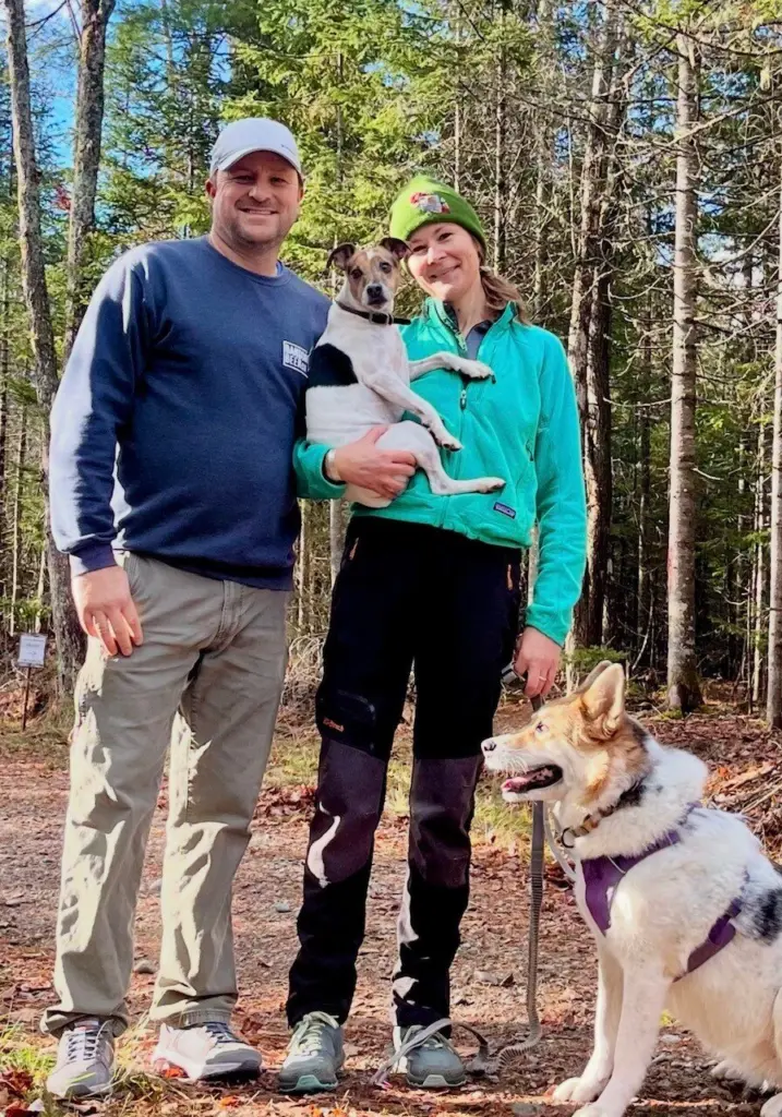 Kimber Friedrich on a wooded trail with her dogs