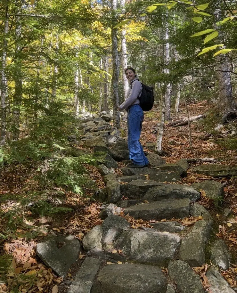 Sophia Toscano hiking a wooded trail